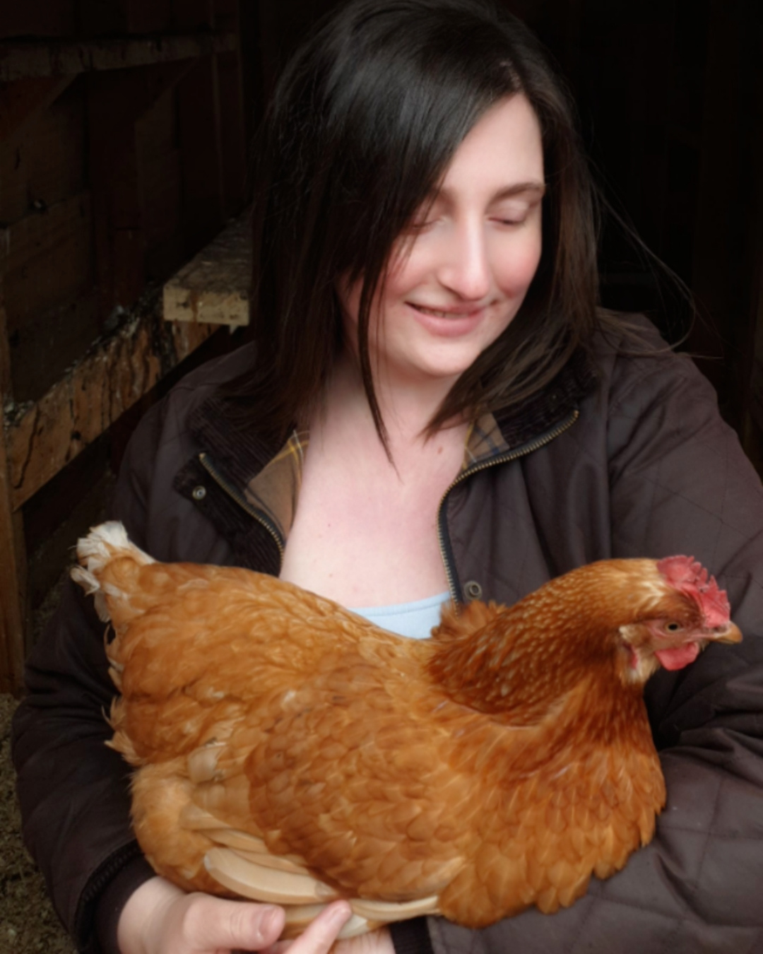 Kayleigh from Kayle at Home holding a chicken – ethical skincare founder with a love for sustainable living and animals