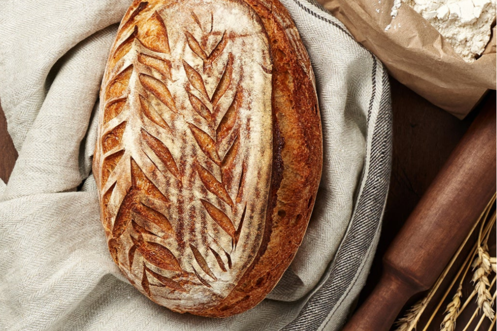 Freshly baked golden-brown sourdough loaf with a crisp crust
