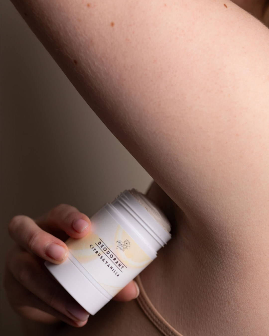 Person applying citrus and vanilla natural deodorant under arm – tallow-based, aluminium-free, for sensitive skin