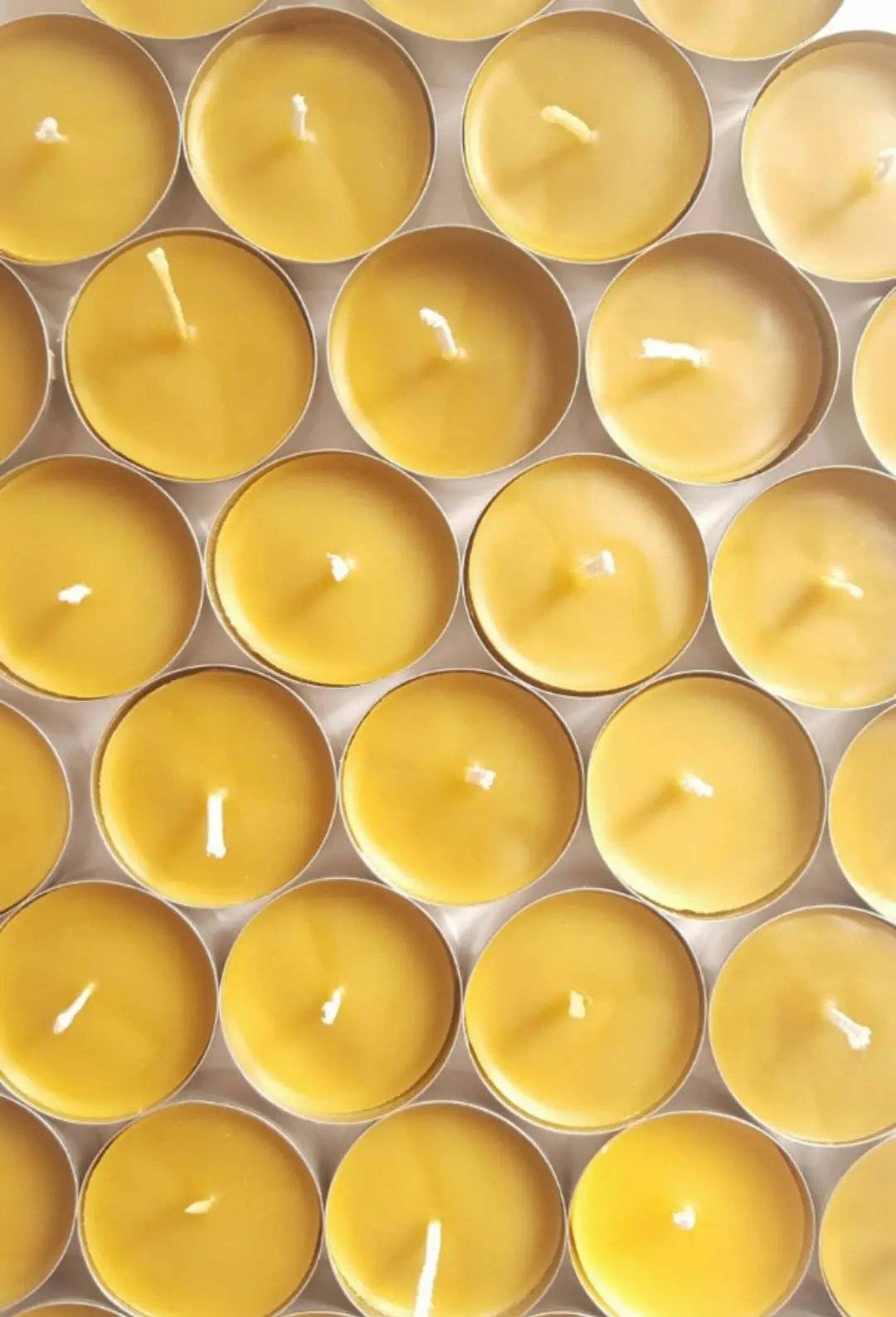 a group of yellow candles sitting on top of each other