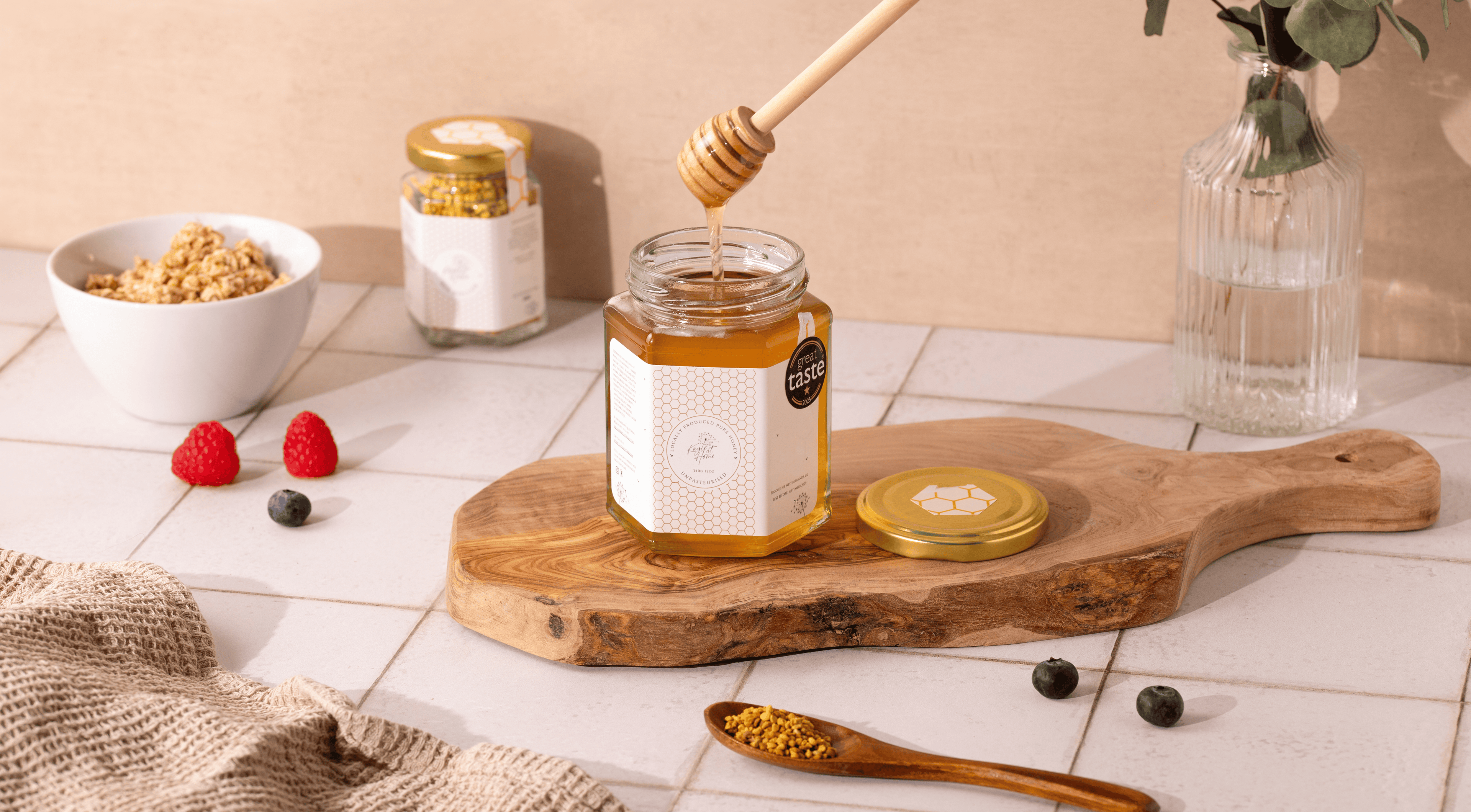 award winning honey on chopping board with berries and pollen around