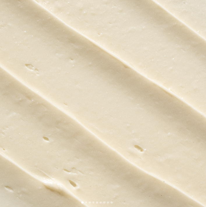 Close-up of whipped body butter with a smooth, creamy texture, showing its rich and nourishing consistency